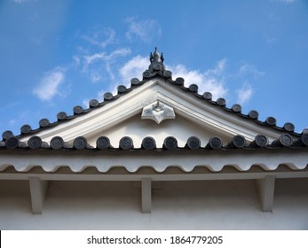 Looking Up To Old Traditional Japanese House Pagoda Roof With Black Clay Roof Tile Decorated With Koi Carp Fish Sculpture On Roof Ridge
