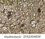 
looking on the the surface ground of rural gravel road texture.