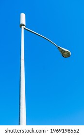 Looking Up On A Typical Small Cell Antenna For 5G Wireless Network Installed On A Street Light Pole. Blue Sky