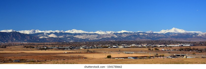 looking out  at boulder's flat irons, long's peak,  rock creek open space, and the  front range of colorado's rocky mountains from broomfield, colorado, on a sunny day in early winter