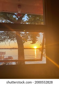 Looking Out A Cabin Window At A Lake In Minnesota During Sunset