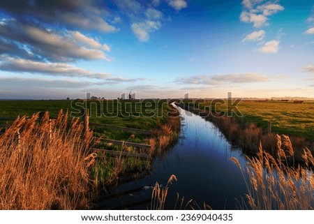 Looking out to Halvergate Mill on Berney Marshes in the Norfolk Broads near Great Yarmouth, also known as Mutton's Mill