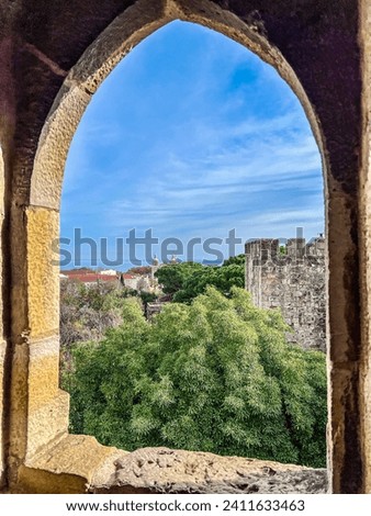 Looking out at Saint George's Castle tower from a small window