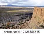 
looking out from the sandstone bluffs overlooks at lava fields in el malpais national monument, near grants,  in northern new mexico