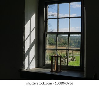 Looking out window at fall landscape, colonial building.