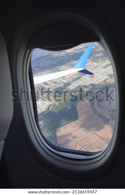 Looking outside a window on plane while\
flying at low altitude                              \
