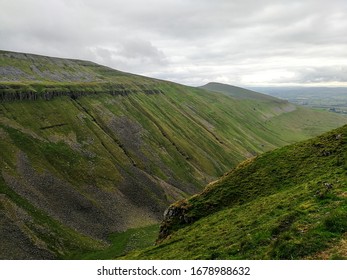 Looking over the edge of the High Cup valley at the scree covered slopes below, North Pennines, UK