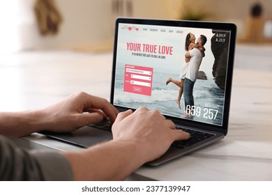 Looking for partner. Man using laptop at home, closeup. Dating site webpage on device screen