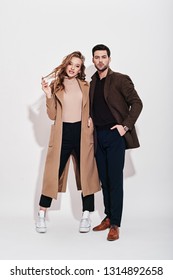 Looking perfect together. Attractive and well-dressed couple posing in studio. Isolated over grey background. - Shutterstock ID 1314892658
