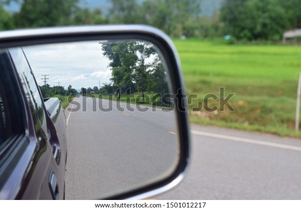 Looking at the rear
mirror when driving a car.9/9/2019.Chat Trakan District /
Phitsanulok - Thailand
Province