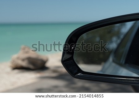 Looking at rear mirror while driving along the Casey Key Beach, Florida
