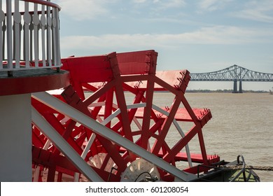 Looking at a red paddlewheel and back at the farthest downstream bridge on the Mississippi River.  Copy space in upper part of frame.