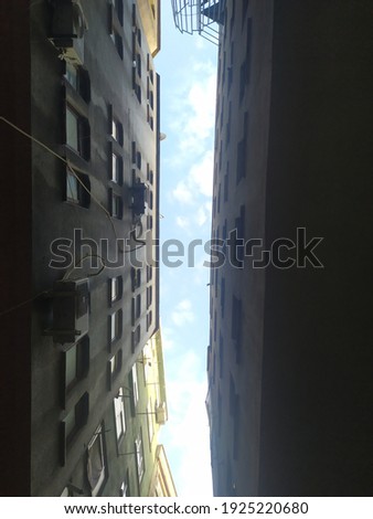 looking at the sky between two buildings