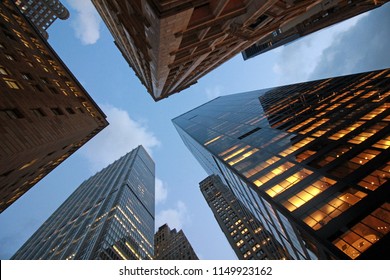 Looking Up At Sky Through Skyscraper Buildings In Manhattan, New York