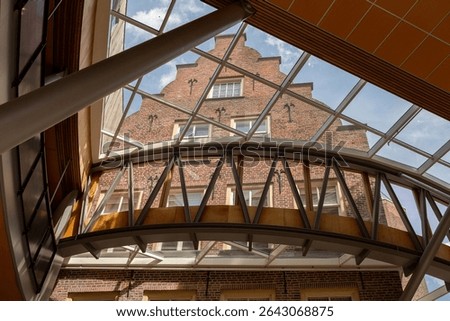 Looking up at skylight from interior architecture of tower town Zutphen City Hall with modern architectural details integrated in historic Dutch building