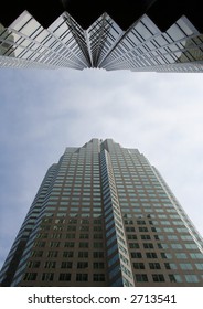 looking up at skyscraper from base on narrow street