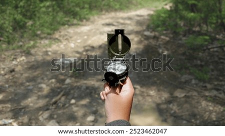 looking for a spot as a reference in determining position coordinates in land navigation and topography using a sighting compass