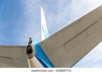 Looking up to the tail and stabiliser of a blue aircraft