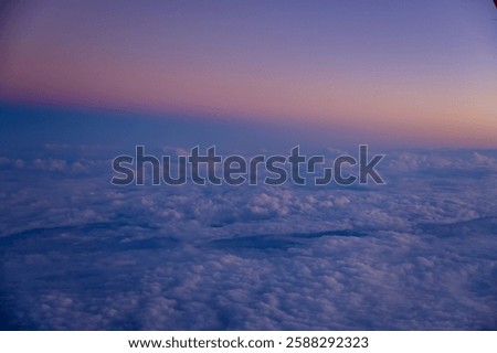 Looking through the airplane window with the sunset sky. Romantic sky, golden hours, colorful sunset sky with clouds. Stunning cloudscape and skyscape. Nature concept. For background use.