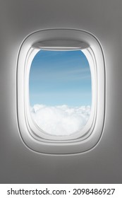 looking through a big jet passenger plane window, above the clouds