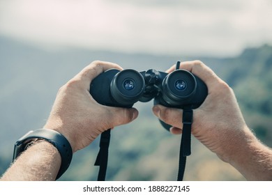 Looking through the binoculars. Concept of active travel