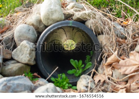 Similar – Image, Stock Photo Look through stone pipes with resistant glaze placed on the ground in front construction site