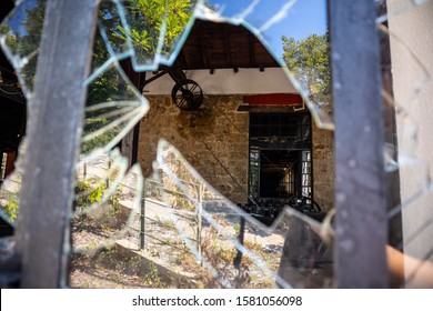 Looking Through Broken Window At Stone Factory Warehouse