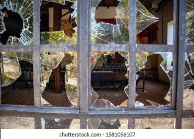 Looking Through Broken Window At Stone Factory Warehouse