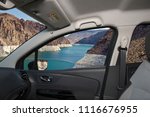 Looking through a car window with view of Colorado river in front of the Hoover Dam on the Nevada side, USA