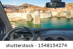 Looking through a car windshield with view of Hoover Dam and Colorado River at the border between Nevada and Arizona, USA