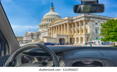 Looking through a car windshield with view of United States Capitol building, iconic home of the United States Congress, Washington DC, USA