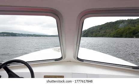 Looking through the front windows of a small motor boat on Lake Windermere in the Lake District, England