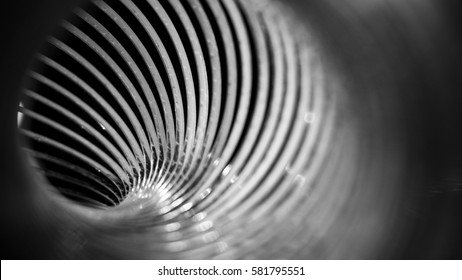 Looking through the inside of s metal spiral slinky 
