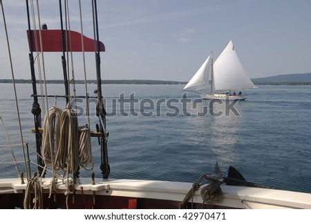 Looking through the rigging of old windjammer at Beautiful sail boat with sails filled and billowing.