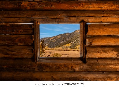 Looking Through Window Ashcroft Ghost Town Cabin in Colorado with Peak Fall Colors