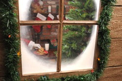 Looking Through The  Window Of A House As Santa Claus Takes A Cookie And And Glass Of Milk.
