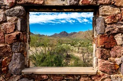 Looking Through The Window At The Picturesque Desert Landscape From The Ruins Of A Stone House On The Bowen Trail In Tucson Arizona.