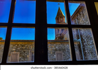 Looking through window at stone tower