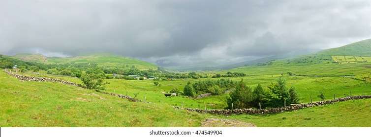 Looking Towards Across Open Countryside From Joyce's Country Towards Lough Mask  Showing Storm Clouds And Shadows Rolling Over The Partry Mountains In Summer Time, County Mayo, Ireland