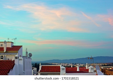 Looking towards the mountain range of Serra de Monchique, at twilight, from over the roof tops of the beautiful town of Lagos, The Algarve, Portugal