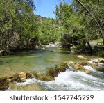 Looking upstream as Fossil Creek flows alternately peaceful and turbulent through forested banks; Fossil Creek Wilderness in Arizona