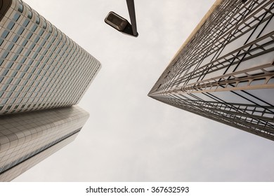 Looking up view of sharp angles on tall buildings in downtown Frankfurt Germany under overcast sky