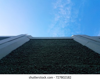 looking up a wall and blue sky