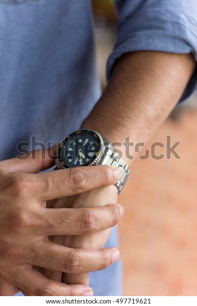 looking a watch ,\
man
