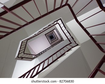 Looking up winding stairwell with geometric pattern