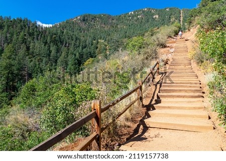 Looking up at wooden steps leading up to the top of Manitou Incline. Manitou Springs Incline is a popular hiking trail rising above Manitou Springs, Colorado
