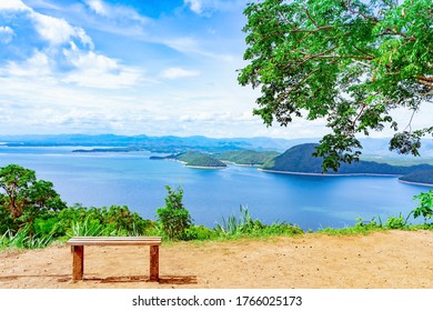 Lookout point with resting wooden bench. Beautiful scenery of nature with a large reservoir above the Srinagarind Dam at Rai Ya Yam view point in Si Sawat District, Kanchanaburi Thailand. - Powered by Shutterstock