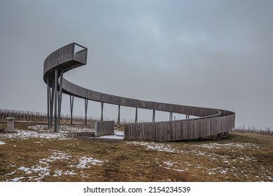 Lookout tower at Kobyli Vrch, South Moravia region,Czech republic.Wooden spiral construction within vineyards.Palava hills,famous wine area.Winter weather,cloudy sky after snowing.Modern architecture - Shutterstock ID 2154234539