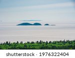 Lookout view of scenic Kama Bay Lake Superior Nipigon Ontario Canada on a hazy summer morning showing shoreline, forest and islands 