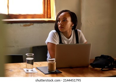 Looks Like Im The Only One Doing Work Here Today. Shot Of An Attractive Young Woman Using Her Laptop While Relaxing Inside A Local Cafe.